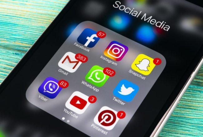 Sankt-Petersburg, Russia, November 13, 2017: Smartphone with icons of social media on screen on green wooden table. Smartphone life style smartphone. Starting social media application whatsapp, viber, facebook, instagram, twitter, pinterest. Photo taken in Business center November 13 2017